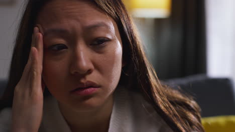 Close-Up-Of-Stressed-Or-Anxious-Woman-Suffering-With-Depression-Anxiety-Or-Loneliness-Sitting-In-Room-At-Home